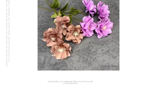 Detailed overhead view of realistic purple and coffee silk anemone flowers with green leaves