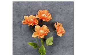 Close-up of four orange artificial anemone flowers with realistic petals and leaves