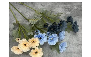 Detailed view of multi-head artificial zinnias with realistic petals and green leaves