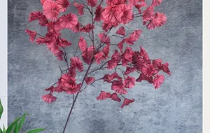Detail view of deep red artificial trumpet flowers with wrinkled petals for decor