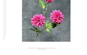 Detailed view of artificial dahlia with vibrant magenta petals and green leaves
