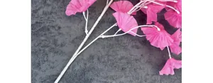 Close-up of pink silk trumpet flowers with detailed petal textures and white stems