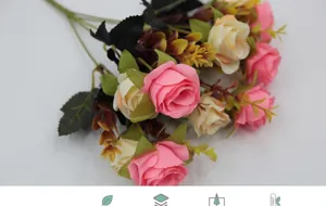 Detail of lifelike pink and cream silk rose bouquet with realistic green leaf textures