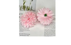 Detailed view of pink fabric hydrangea head with plastic green base for DIY crafts