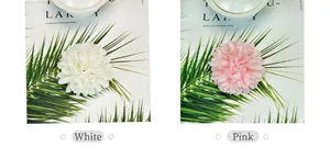 Detailed close-up of white and pink artificial chrysanthemum flowers made of silk fabric