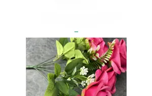 Detailed texture of dark pink silk rose petals and green leaves in a floral bouquet