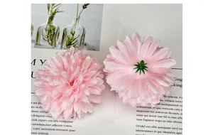 Detailed view of pink silk daisy flower heads showing front petals and green plastic base