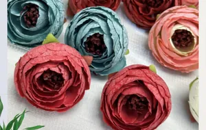 Macro detail of artificial silk rose heads with multilayered petals and textile textures