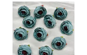 Flat lay of artificial vintage teal silk flower heads for DIY wedding decorations