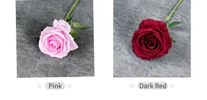 Detail view of pink and dark red velvet artificial roses with realistic green leaves