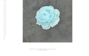 Detailed view of light blue multi-layered fabric peony flower for DIY wedding accessories