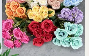 Flat lay of colorful artificial silk rose bouquets for elegant home wedding decor