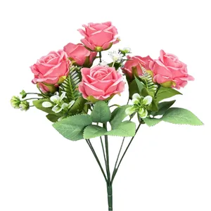 Artificial bouquet with realistic pink roses, small white accents and lifelike green leaves