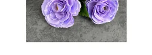 Close-up of purple faux ranunculus with layered petals and realistic green leaves