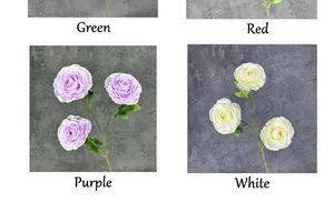 Close-up of four colors of artificial ranunculus flowers with realistic green leaves