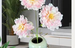 Pink and white peony flower arrangement in a celadon ceramic vase for home decor