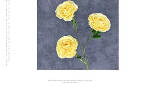 Detailed view of artificial yellow Persian Buttercup with three heads and green leaves