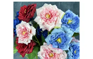 Close-up of silk artificial queen roses in deep red, pink and blue for home decoration