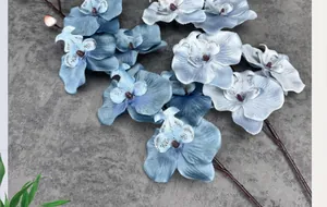 Macro shot of artificial phalaenopsis orchids with gradient blue petals and realistic texture