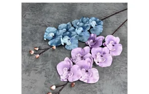 Detailed close-up of blue and purple artificial orchids with natural petal textures