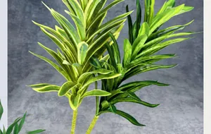 Close-up of artificial Dracaena leaves with vibrant green and yellow striped textures