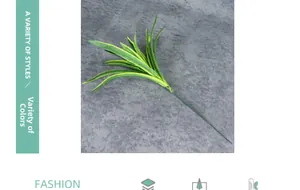Detail view of artificial spider plant with green and yellow variegated lanceolate leaves