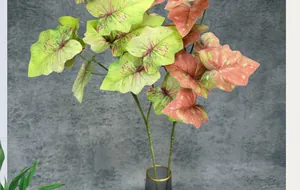 Close-up of lifelike 3D caladium leaves with red veins in a glass vase for home decor