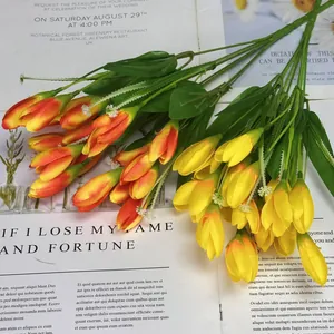 Artificial orange and yellow tulip bouquet with white buds for home and hotel decoration
