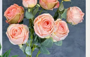 Detailed close-up of realistic gradient pink silk roses with layered petals and leaves