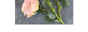 Close-up of artificial oil-painted roses with burnt edges and realistic pink petals