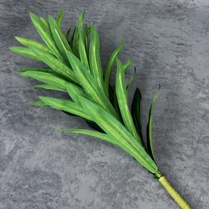 Artificial Dracaena plant branch with green striped leaves for home decor on grey fabric