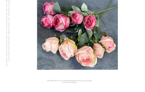 Detail view of artificial Milan roses in deep pink and champagne colors with green leaves