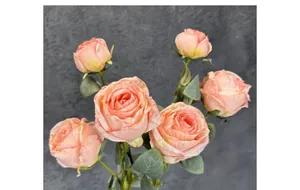 Close-up of artificial gradient pink roses with realistic petal textures and green leaves