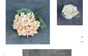 Detail of lush cream and white artificial hydrangea petals with realistic green leaves