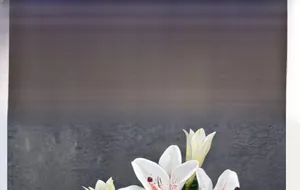 Detailed view of realistic 3-head white faux lily with lifelike red stamens and petals