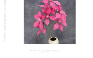 Detailed view of pink artificial poinsettia with velvet petals in a white ceramic vase