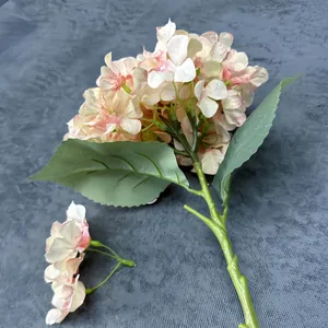 Realistic cream and pink gradient faux hydrangea stem with green leaves for home decor