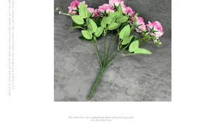 Detailed top view of purple faux velvet roses with green foliage on gray textile