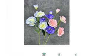 Detailed view of lifelike artificial Eustoma flowers with blue and pink petals and green leaves