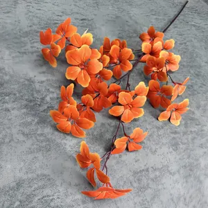 Close-up of lifelike orange artificial flower petals with realistic autumn textures