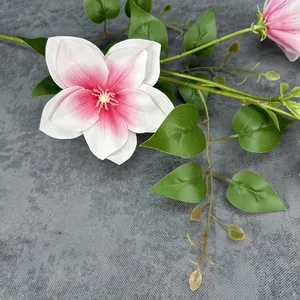3D printed clematis artificial flower with pink gradient petals on grey fabric
