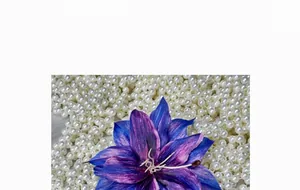 Detail of blue and purple silk lily flower petals with realistic pistils on pearl background