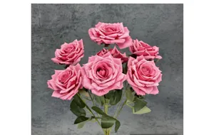 Close-up of artificial deep pink roses showing realistic fabric petals and green leaves