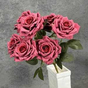 Elegant vintage dark pink artificial rose bouquet in a minimalist white ceramic vase