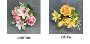 Detail view of dark pink and yellow silk rose lily bouquets with green foliage
