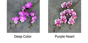 Close-up of 3D artificial orchid stems in deep purple and white with purple center