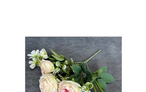 Detailed close-up of light pink and cream silk peonies with lifelike green leaves