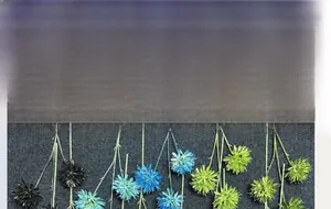 Close-up detail of three-headed artificial onion ball flowers in blue, black and green