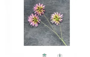 Detail of a 3-headed artificial onion ball flower with purple petals and green stem