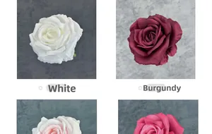 Detail of multi-layered artificial rose heads in white and wine red silk fabric